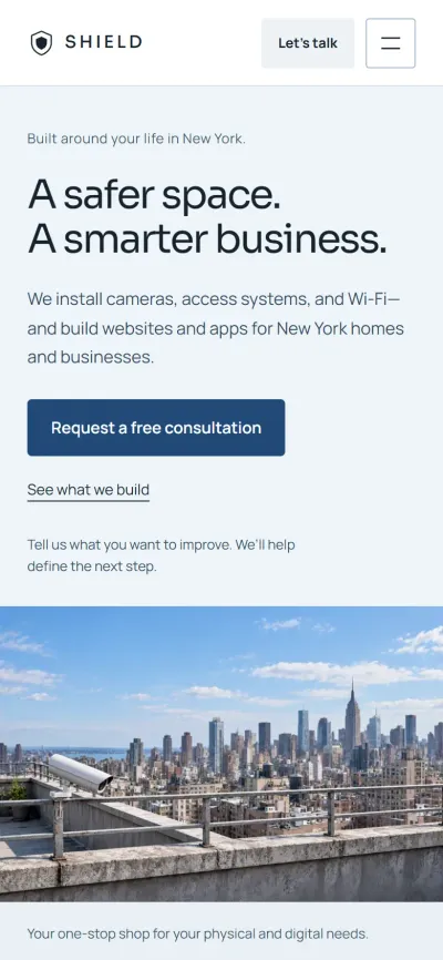 The Shield Security Solutions home page on a phone, with the headline and consultation button.